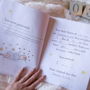 May include: A baby's birth announcement book with a handwritten entry for September 11, 2018. The book includes details about the baby's birth weight, length, and eye and hair color. The book also includes a section for the baby's arrival time and original due date.