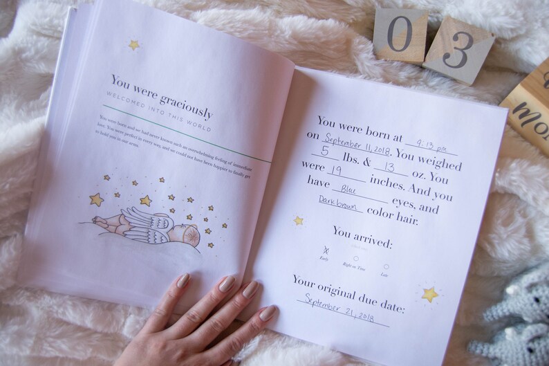 May include: A baby's birth announcement book with a handwritten entry for September 11, 2018. The book includes details about the baby's birth weight, length, and eye and hair color. The book also includes a section for the baby's arrival time and original due date.