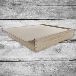 May include: A wooden box with a hinged lid. The box is made of natural wood and has a simple, rustic design.