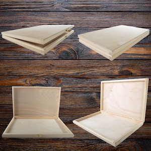May include: Four wooden boxes with hinged lids. The boxes are made of light wood and have a natural finish. The boxes are arranged in a grid pattern on a dark wood background.