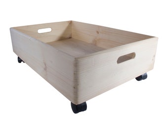 May include: A natural wood storage box with two handles and four black wheels. The box is made of unfinished wood and is ready to be painted or stained.