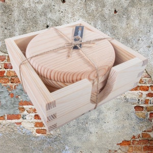 May include: Set of four round wooden coasters in a natural wood finish, packaged in a wooden box with a label that says "woodbee".
