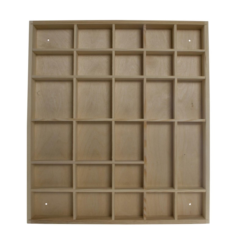 May include: A wooden storage shelf with 24 square compartments. The shelf is made of light wood and has a natural finish.
