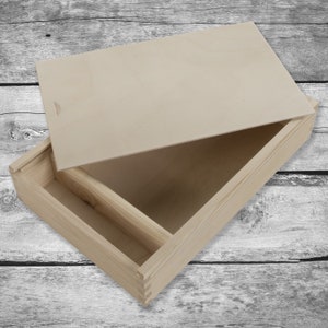 May include: A wooden box with a hinged lid, the lid is open and the box has a divider inside. The box is made of natural wood and has a light brown color.