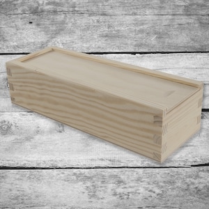 May include: A plain wooden box with a hinged lid. The box is made of light-colored wood with a natural finish. The box is empty and ready to be filled with your favorite items.