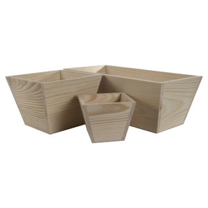 May include: A set of three unfinished wooden planters in different sizes. The planters are square or rectangular with a tapered design. The wood grain is visible, and the planters are light brown in colour.