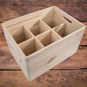May include: A wooden crate with six compartments, perfect for storing and organizing bottles. The crate is made of natural wood and has a rustic look.