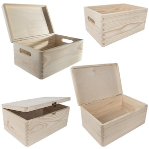 May include: Four wooden boxes with lids. The boxes are made of natural wood and have a simple design. Two of the boxes have handles on the sides. The boxes are all closed, but the lids are open.
