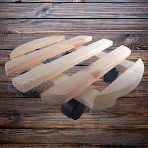 May include: A wooden plant stand with four wheels. The stand is made of natural wood and has a slatted design. The wheels are black and are located on the bottom of the stand.