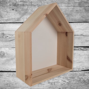 Może przedstawiać: Drewniana półka w kształcie domu z białym tłem i jedną półką. Półka wykonana jest z naturalnego drewna i ma rustykalny wygląd.