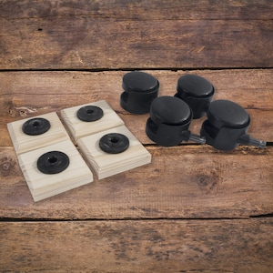 May include: Four wooden squares with black rubber circles on top and four black caster wheels with a metal axle.