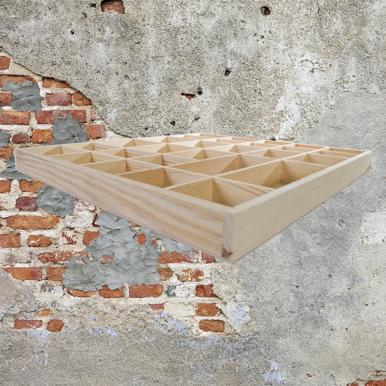 May include: A wooden storage box with multiple compartments. The box is made of light wood and has a rectangular shape.