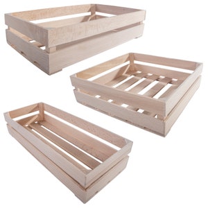 May include: Three wooden crates of varying sizes. The crates are made of natural wood and have a rustic look. They are ideal for storing and displaying items.