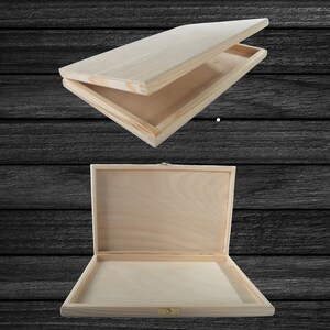 May include: A plain wooden box with a hinged lid. The box is open and the lid is propped up. The box is made of light-coloured wood and has a natural finish.