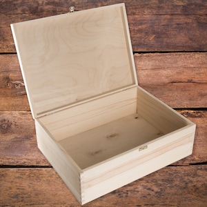May include: A plain wooden box with a hinged lid and a brass latch. The box is open and empty, revealing the natural wood grain inside.