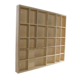 May include: A wooden shelf unit with 24 individual compartments. The shelf is made of unfinished pine wood and is ready to be stained or painted.