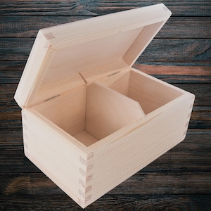 May include: A natural wood box with a hinged lid and a divider inside. The box is open and the lid is propped up.