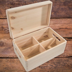 May include: A wooden box with a hinged lid and four compartments inside. The box is made of light-colored wood and has a natural finish.