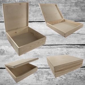 May include: Four wooden boxes with lids, shown from various perspectives. The boxes are crafted from light-coloured wood, with visible grain and dovetail joints. The lids are open or closed, revealing the interior.