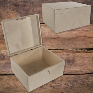 May include: Two wooden boxes, one with the lid open and the other closed. Both boxes are made of light-colored wood and have a simple, rectangular design.
