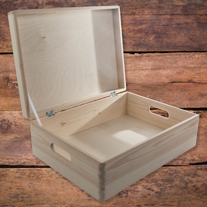 May include: An empty wooden box with a hinged lid and two side handles. The box is made of natural wood and has a light brown colour.