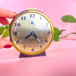 Small DUGENA travel alarm clock, alarm clock Dugena leise-duo beige with gold-colored rim made in the 60s in Germany.