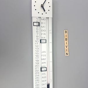 May include: A white wall clock with a calendar and thermometer. The clock face is square with black dots and hands. The calendar displays the month of June. The thermometer shows the temperature in Celsius.