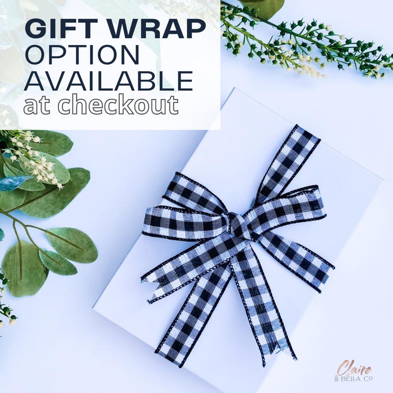May include: A rectangular white gift box tied with a black and white gingham ribbon bow. The text GIFT WRAP OPTION AVAILABLE at checkout is printed in the upper left corner. The brand name Claire & BELLA CO is in the bottom right corner.