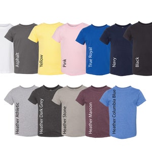 May include: A collection of twelve short-sleeved crew neck t-shirts arranged in two rows. Colors include white, asphalt, yellow, pink, true royal, navy, black, heather athletic, heather dark grey, heather stone, heather maroon, and heather columbia blue.