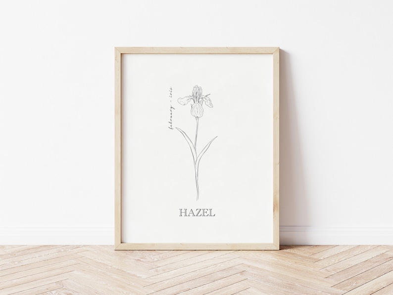 May include: A printable art print with a black and white line drawing of an iris flower. The text "February - Iris" and "HAZEL" are printed below the flower.