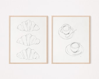 May include: Two framed illustrations, one with three black and white line drawings of croissants, and the other with two black and white line drawings of coffee cups and saucers.