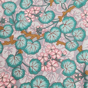 May include: A textile with a floral design. It features teal-coloured leaves, pink flowers, and brown stems set against a grey backdrop. The pattern is a repeating arrangement of stylised botanical elements, giving a vintage feel.
