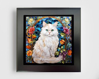 May include: A square framed wall art piece featuring a long-haired white cat with green eyes centered against a vibrant stained glass background. The background displays deep blue geometric patterns surrounded by colorful red, orange, and pink flowers.