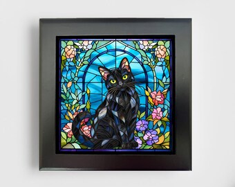 May include: A square black frame containing a stained glass style artwork of a black cat with yellow eyes. The cat is centered against a blue arched background surrounded by colorful pink, purple, and peach flowers and green foliage.
