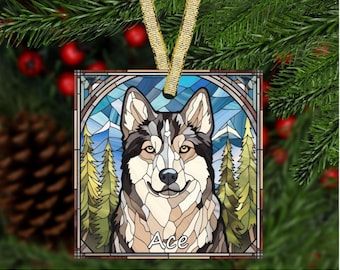 May include: Square ornament featuring a stained-glass style image of a Husky dog named Ace. The dog has brown, gray, and white fur, with a blue and green mountain and forest background. A gold ribbon is attached for hanging.