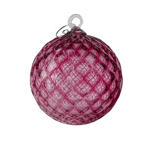 May include: A deep pink glass Christmas ornament with a quilted pattern and a silver wire hanger.