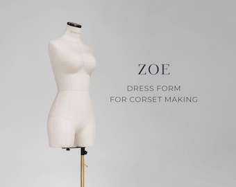 May include: A cream-coloured dress form for corset making, mounted on a gold-coloured adjustable stand. The form has a black neck cap and is labelled "ZOE". The text below reads "DRESS FORM FOR CORSET MAKING".