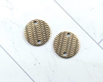 May include: Two gold-toned metal round charms with a wavy pattern and two holes.