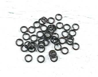 May include: A pile of small, bronze-colored jump rings. The rings are about 6mm in diameter and are perfect for jewelry making.