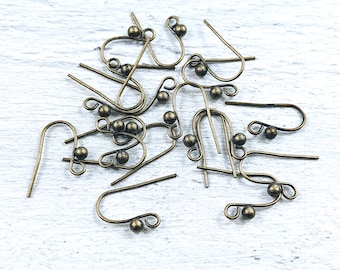 May include: A group of 12 antique gold earring hooks with small round balls at the end of each hook.