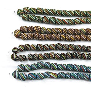 May include: Four strands of colorful glass beads with a spiral pattern. The beads are arranged in rows, with each row featuring a different color combination. The beads are all approximately the same size and shape.