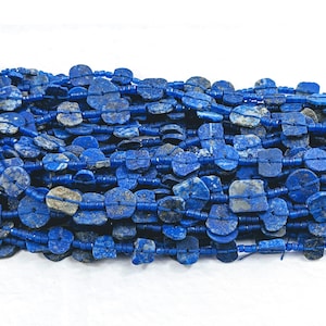 May include: A strand of deep blue lapis lazuli gemstone beads. The beads are irregularly shaped and have a rough, natural texture.