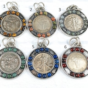 May include: Six silver pendants with different coin designs surrounded by colorful gemstones. The coins feature images of a buffalo, a woman walking, and an eagle. The gemstones are in various colors, including red, blue, green, and brown.