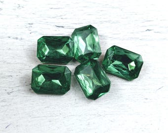 May include: Five emerald green faceted glass gems in a rectangular shape.