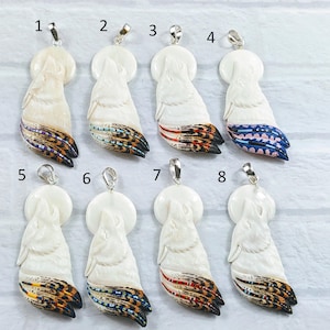 May include: Eight white wolf pendants with different colored feather designs. The pendants are numbered 1 through 8.