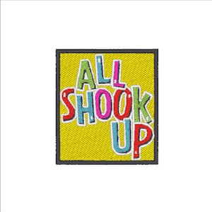 Puede incluir: Un parche cuadrado amarillo con borde negro. El texto "ALL SHOOK UP" está escrito en letras de colores y estilizadas.