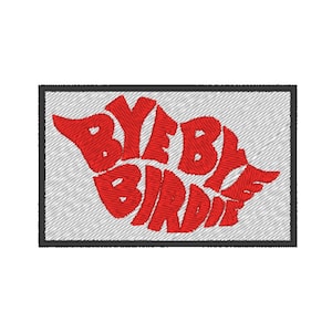 May include: Embroidered patch with the words "BYE BYE BIRDIE" in red, stylized lettering. The patch has a rectangular shape with a black border and a gray background.