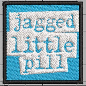 May include: A blue square patch with white text that reads "jagged little pill" in a typewriter font.