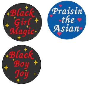 May include: Four embroidered patches with different messages. Two patches are black with gold stars and red text. One says "Black Girl Magic" and the other says "Black Boy Joy". The other two patches are round and blue with white text and pink hearts. One says "Praisin the Asian".