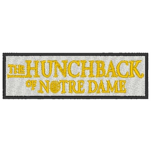 May include: A white embroidered patch with black trim featuring the text "The Hunchback of Notre Dame" in yellow.